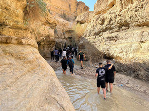Teenagershiking in a riverbed