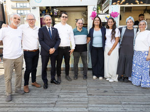 A group of people standing, smiling, and posing for the camera.