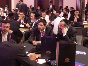 A group of Haredi men seated around a table